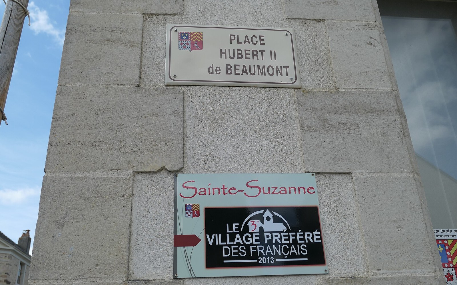 A village school building with a stone plaque above the door